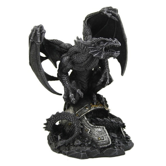 A statuette of a black dragon roaring, standing on top of a Roman helmet.