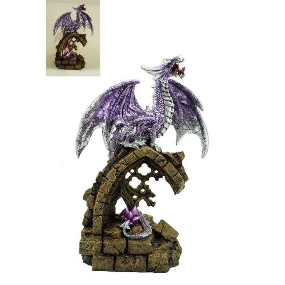 A statuette of a roaring dragon standing atop a destroyed arch window, a giant purple gem by his tale.