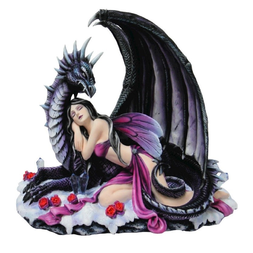 A statuette of a fairy with purple dragonfly wings, wearing a purple belly dancer outfit, resting in the crook of the neck of a protective black dragon.